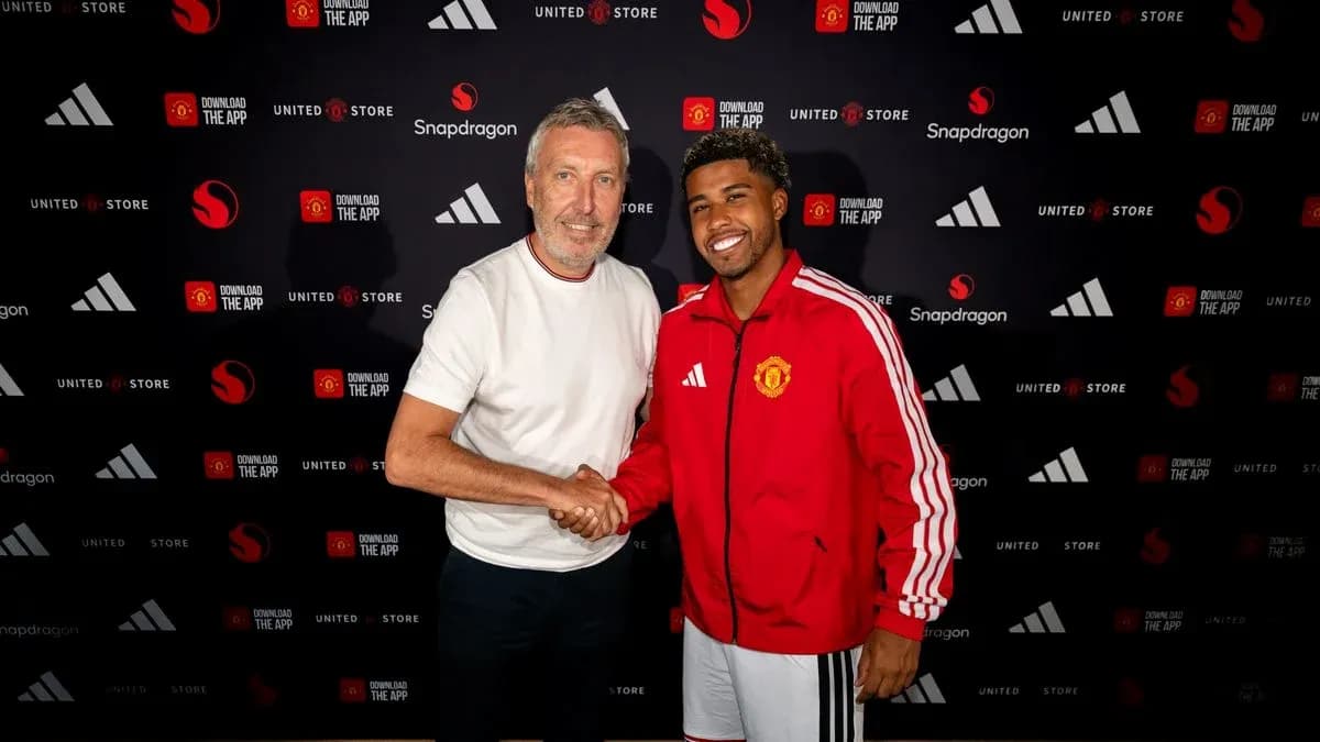 Player and official shaking hands at signing event Player and official shaking hands at signing event