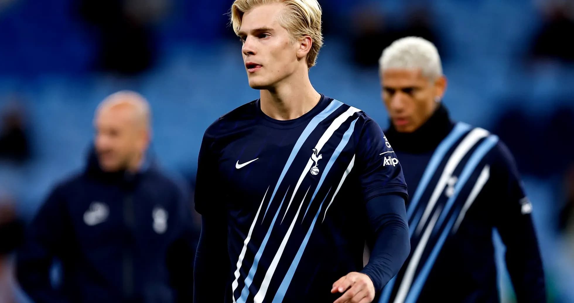 Player walking on pitch in Tottenham training kit Player walking on pitch in Tottenham training kit