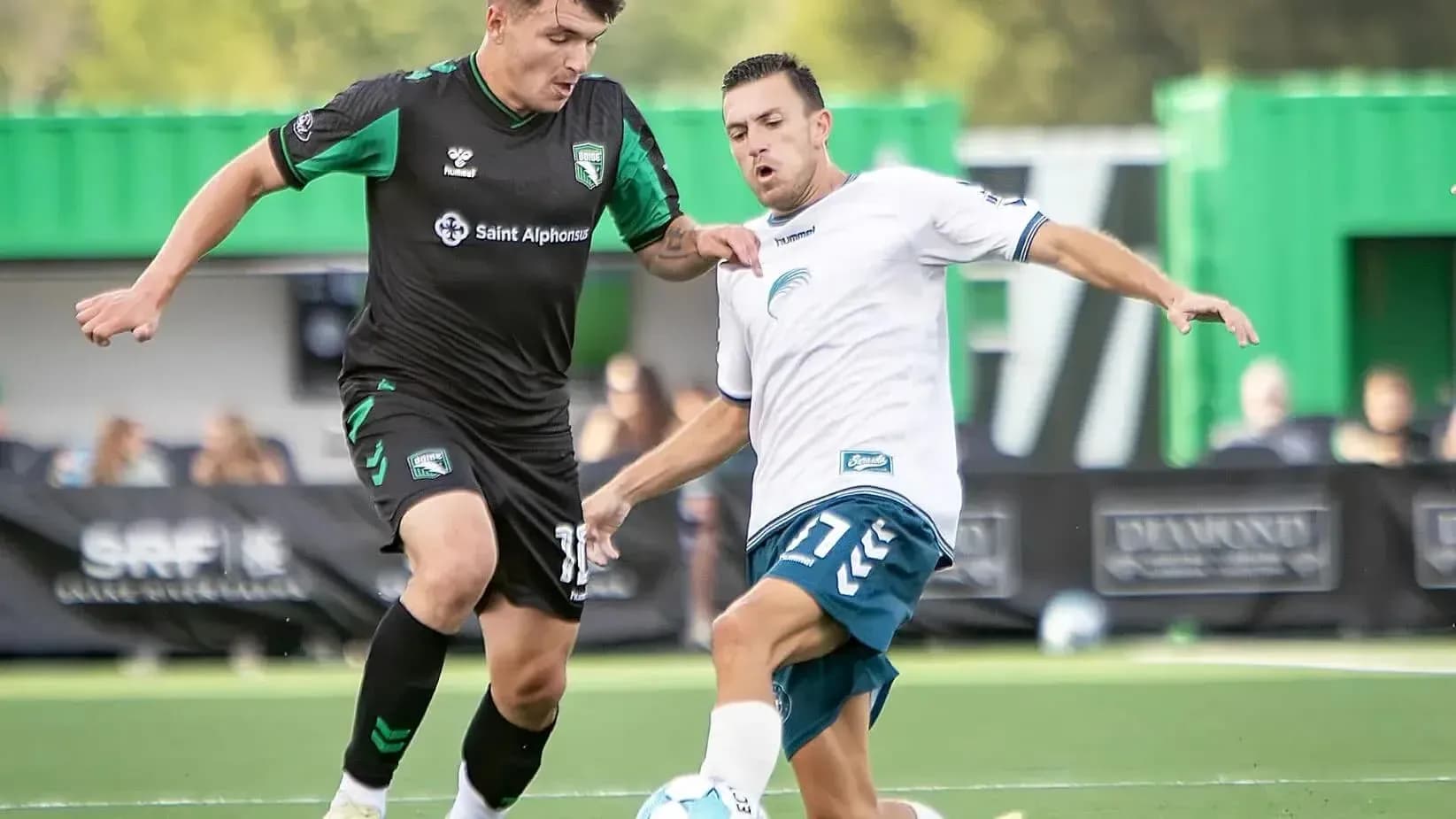 Players competing for the ball during USL match Players competing for the ball during USL match
