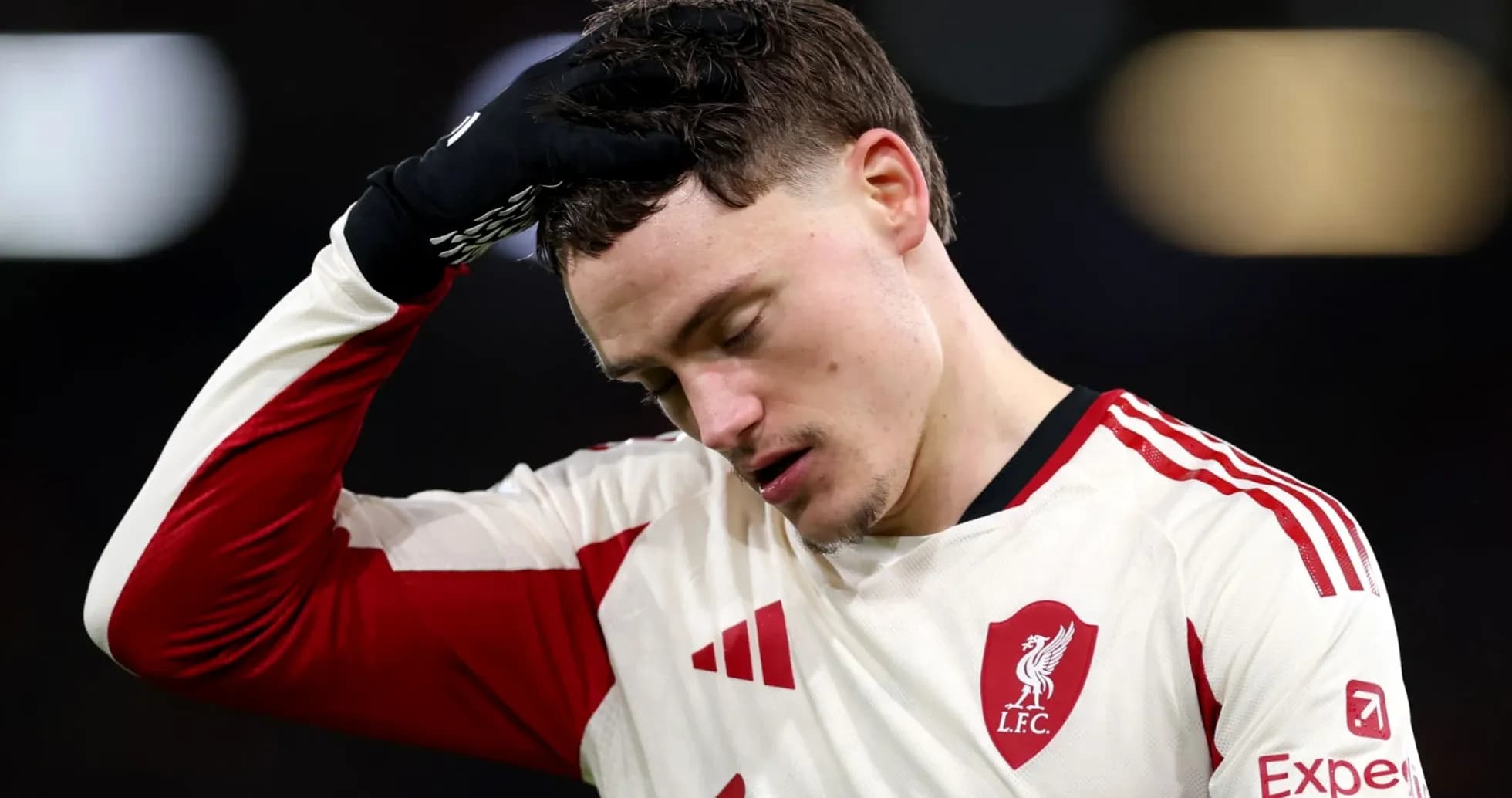 Player in Liverpool kit looking down after match Player in Liverpool kit looking down after match