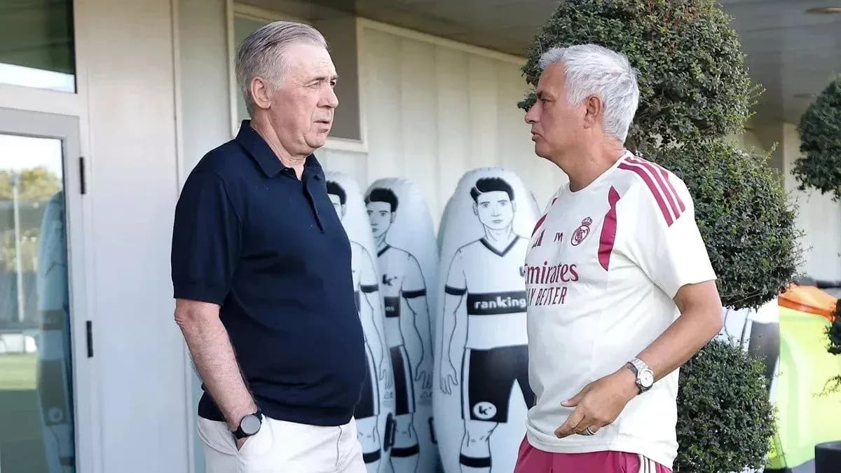 Two coaches talking near training facility Two coaches talking near training facility