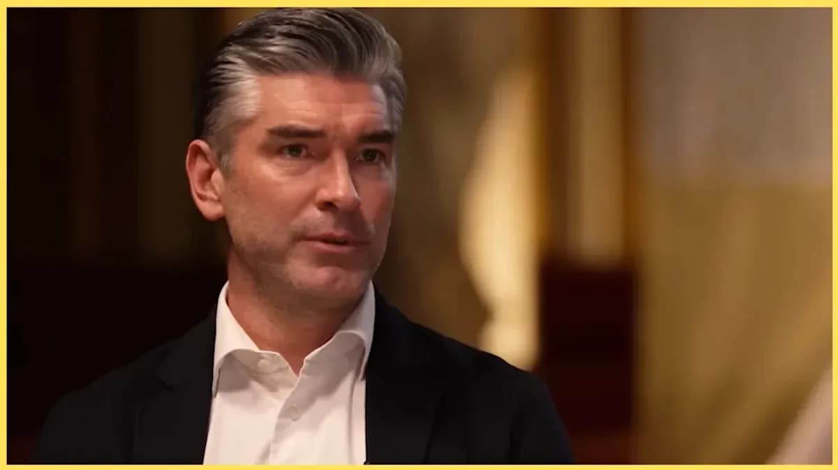 Man speaking during an interview in formal attire Man speaking during an interview in formal attire