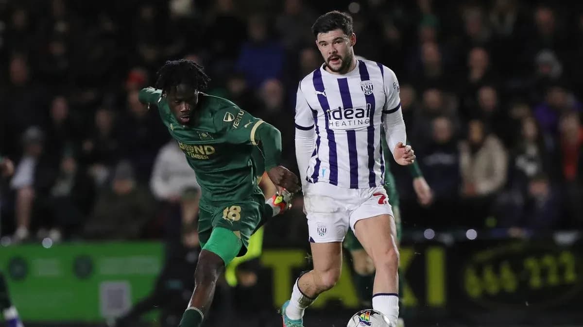 Two football players competing for possession of the ball Two football players competing for possession of the ball
