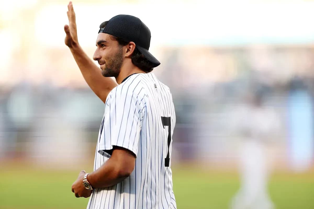 Man waving while wearing a baseball jersey Man waving while wearing a baseball jersey
