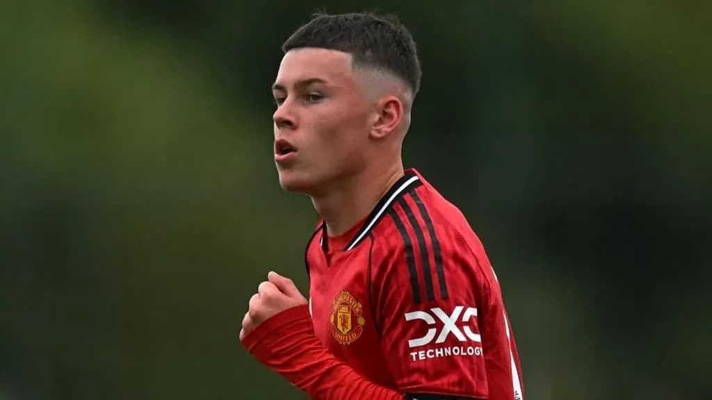Young player in Manchester United training kit running Young player in Manchester United training kit running