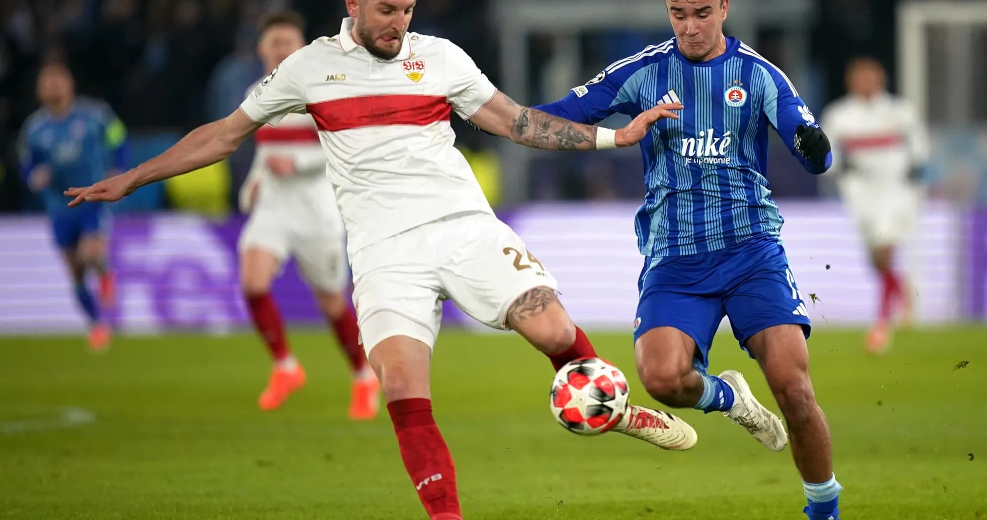 Slovan Bratislava player challenging VfB Stuttgart player Slovan Bratislava player challenging VfB Stuttgart player