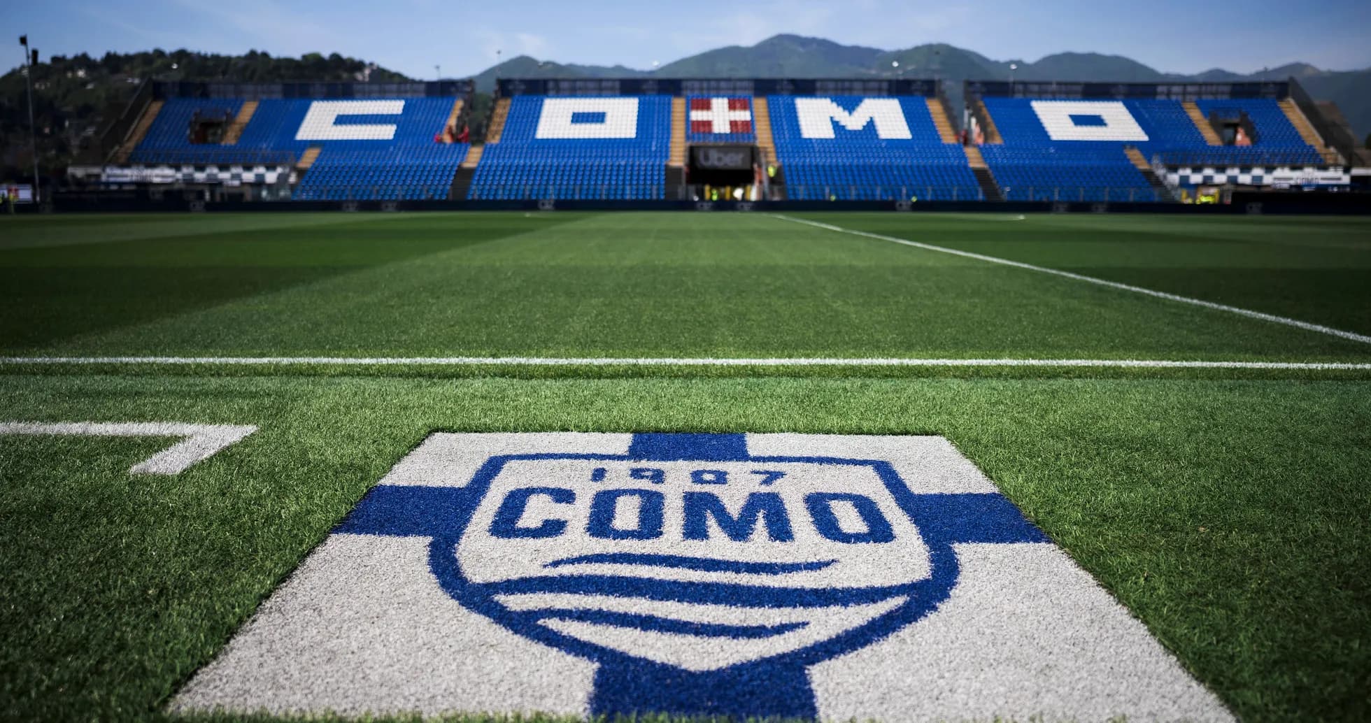 Como stadium with logo on the pitch foreground Como stadium with logo on the pitch foreground