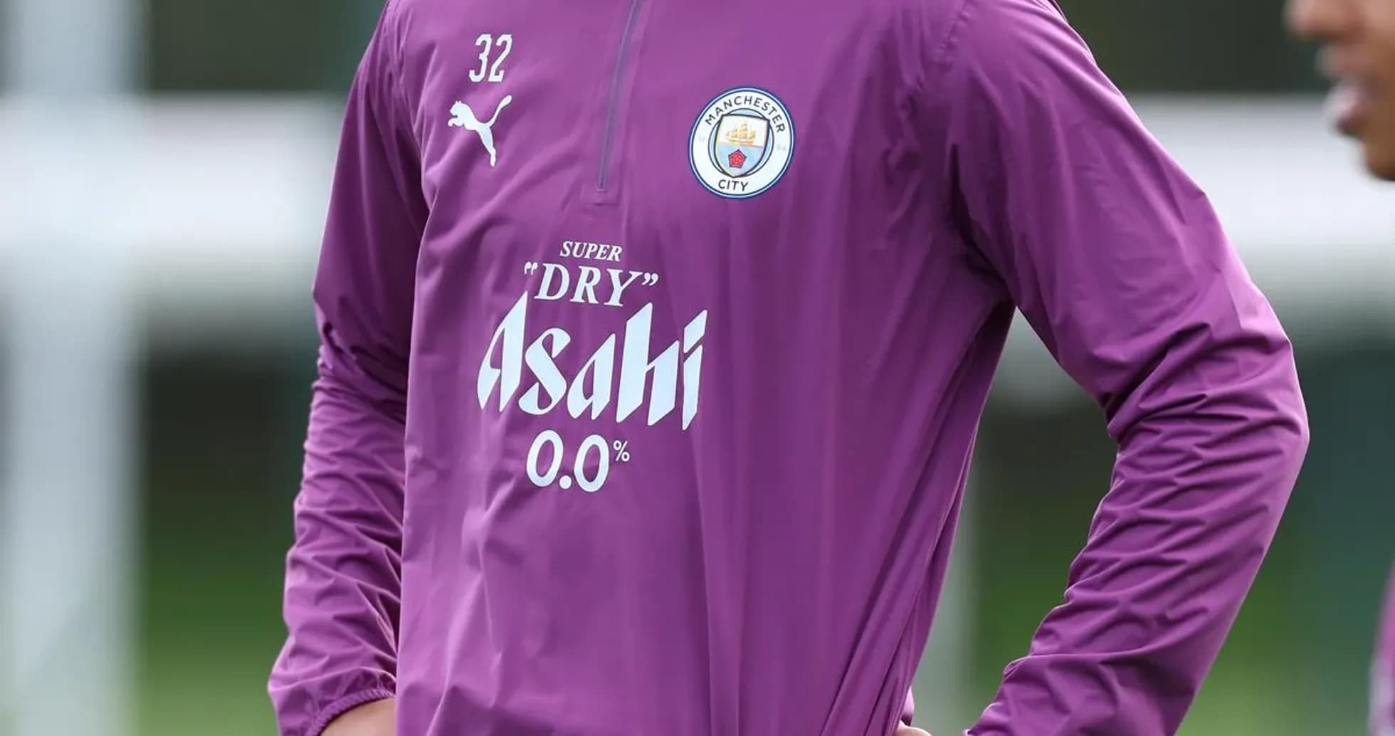 Player in Manchester City training attire on pitch Player in Manchester City training attire on pitch