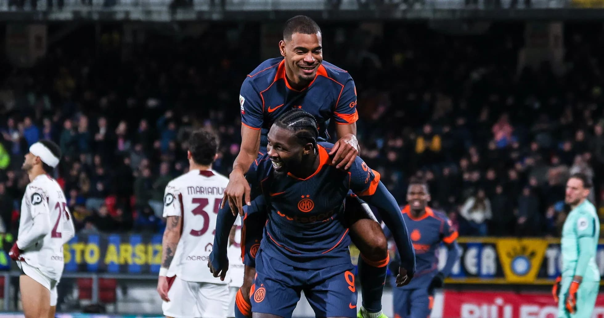 Players celebrating with a piggyback during match Players celebrating with a piggyback during match