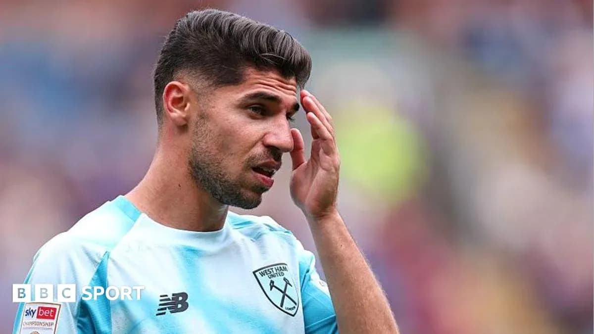 Player touching forehead during match at stadium Player touching forehead during match at stadium