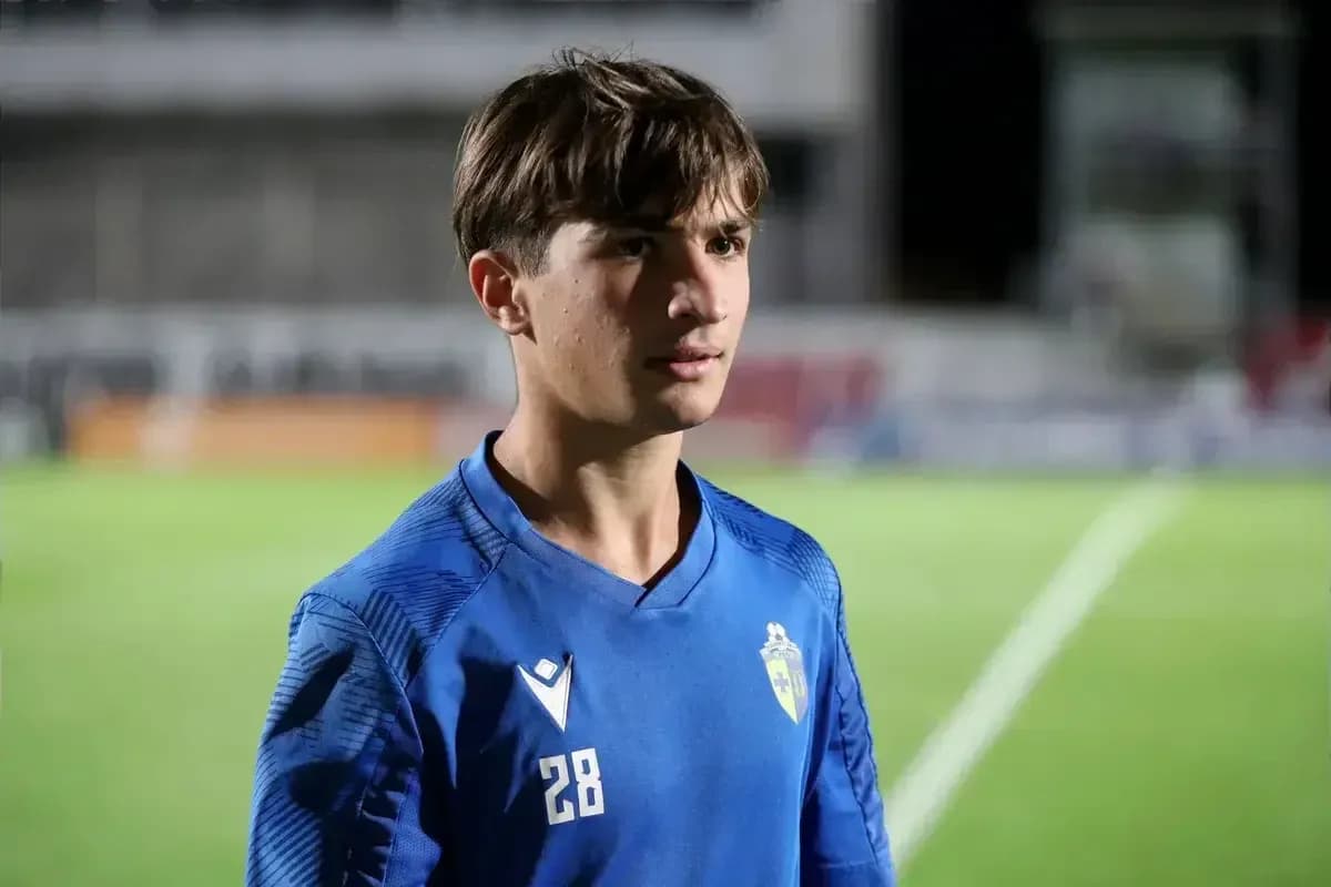 Young player in blue jersey on football field Young player in blue jersey on football field