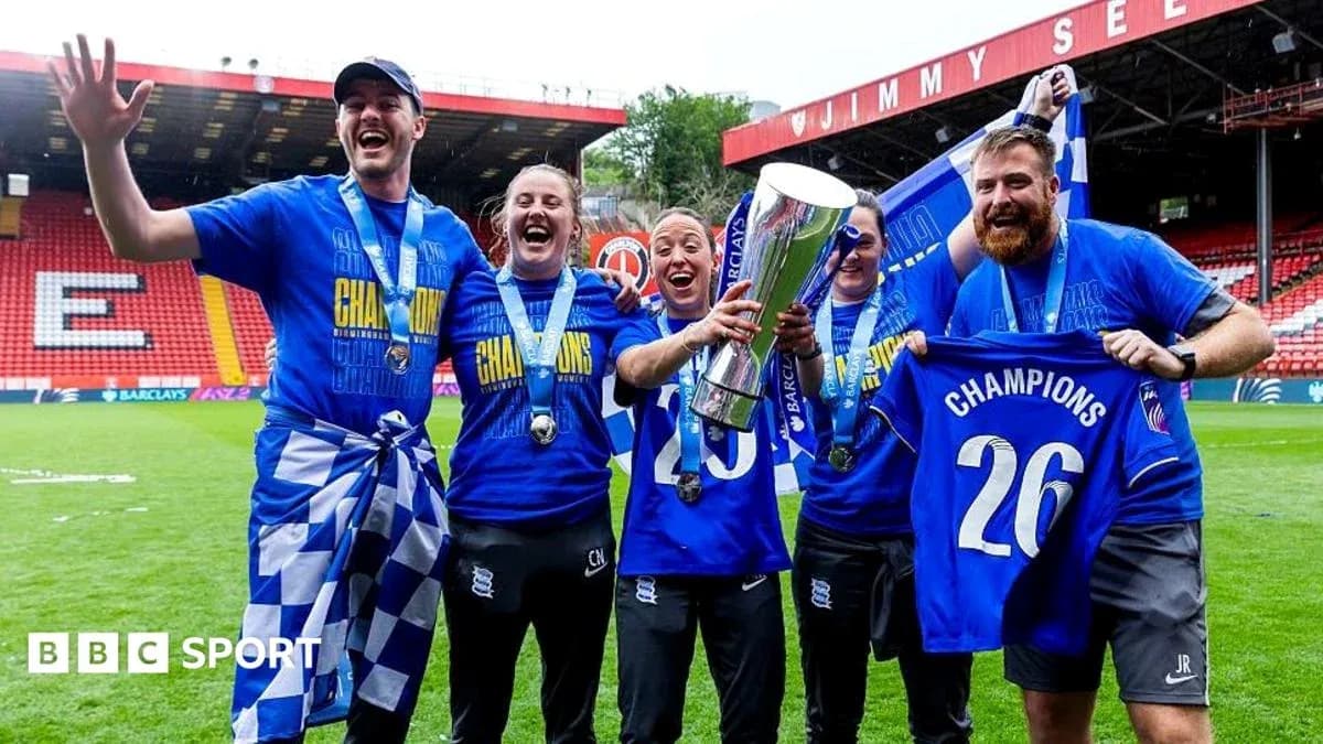 Birmingham City players celebrating with trophy on field Birmingham City players celebrating with trophy on field