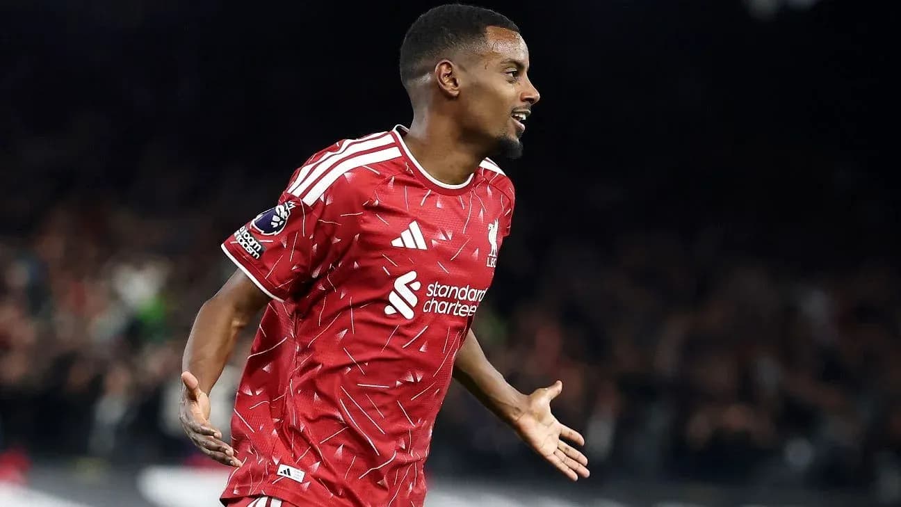 Player celebrating goal in red Liverpool jersey Player celebrating goal in red Liverpool jersey
