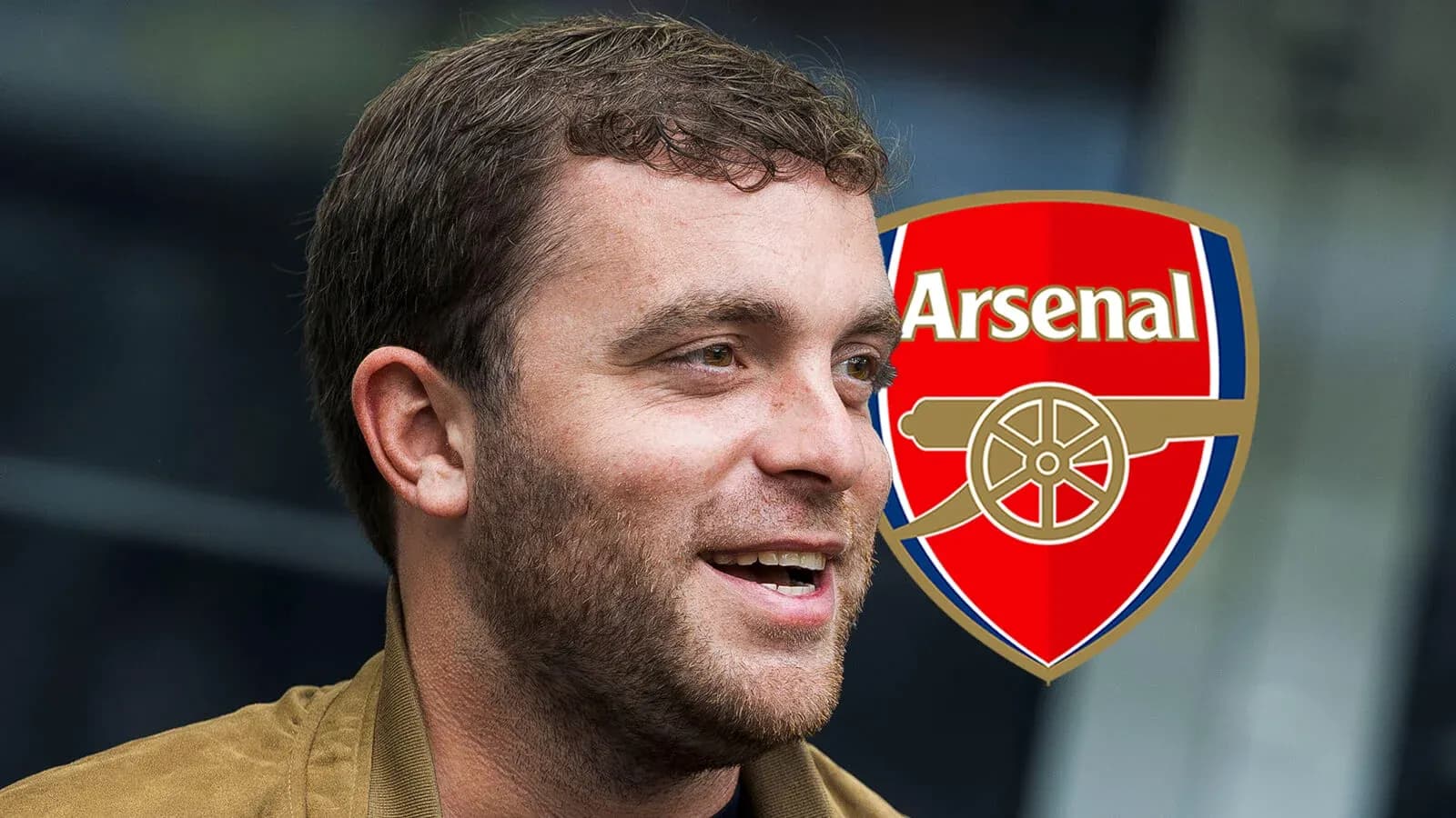 Man smiling with Arsenal logo in background Man smiling with Arsenal logo in background