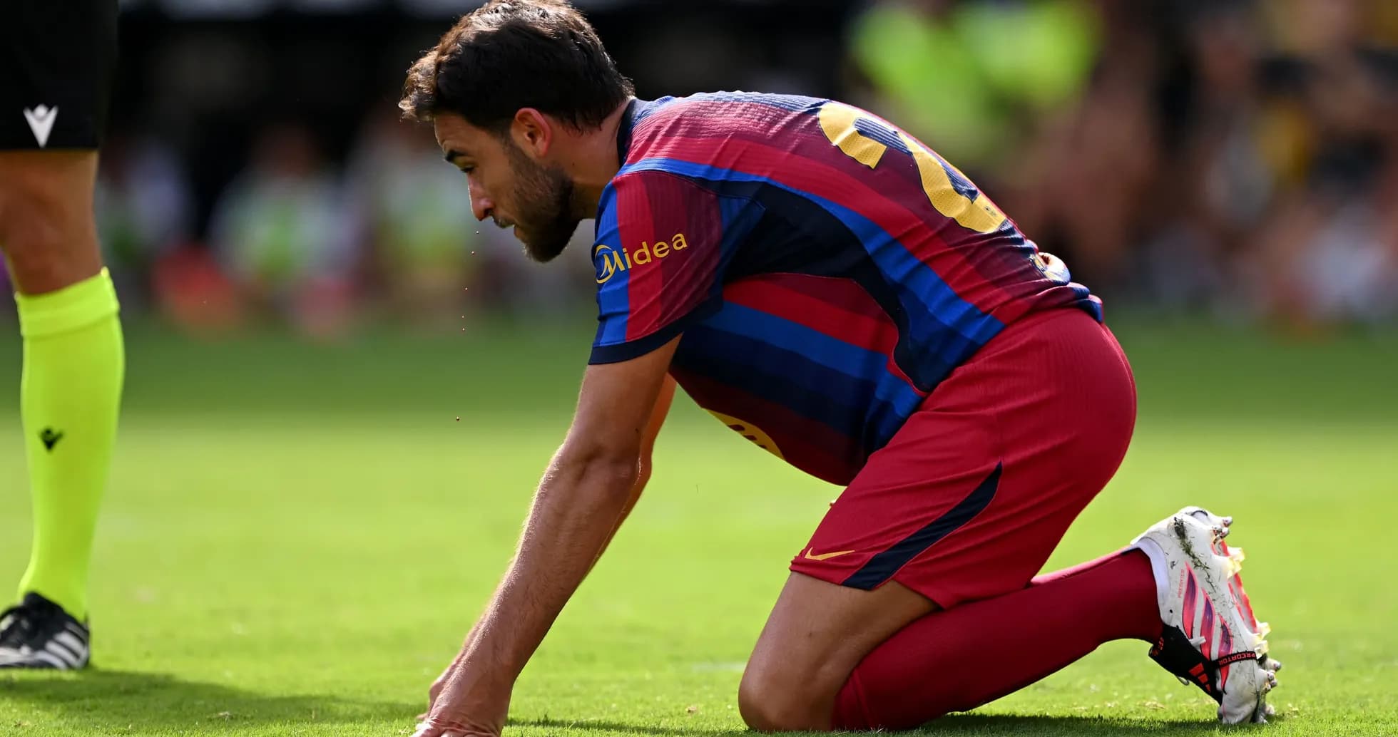 Player on knees on field during match Player on knees on field during match