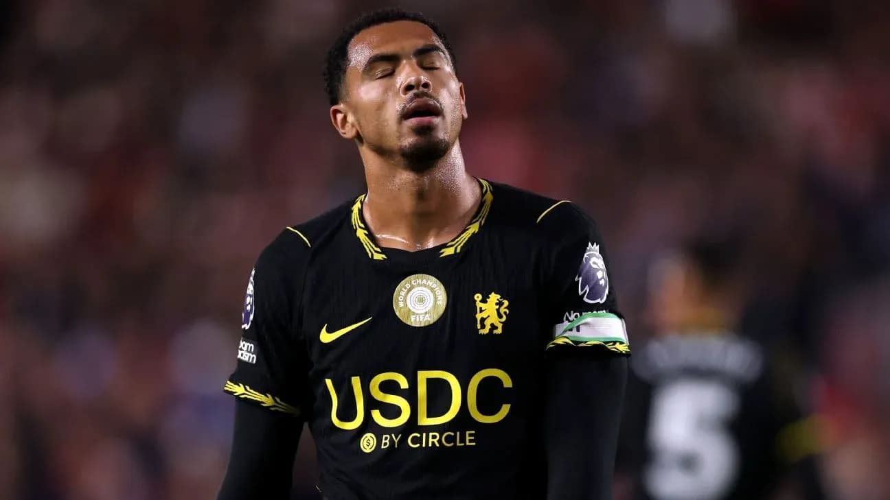 Player in black jersey looking dejected on field Player in black jersey looking dejected on field