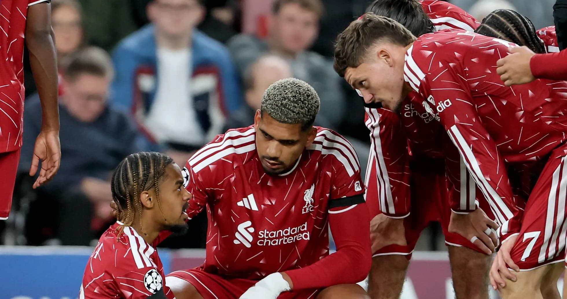 Liverpool players discussing during a match Liverpool players discussing during a match