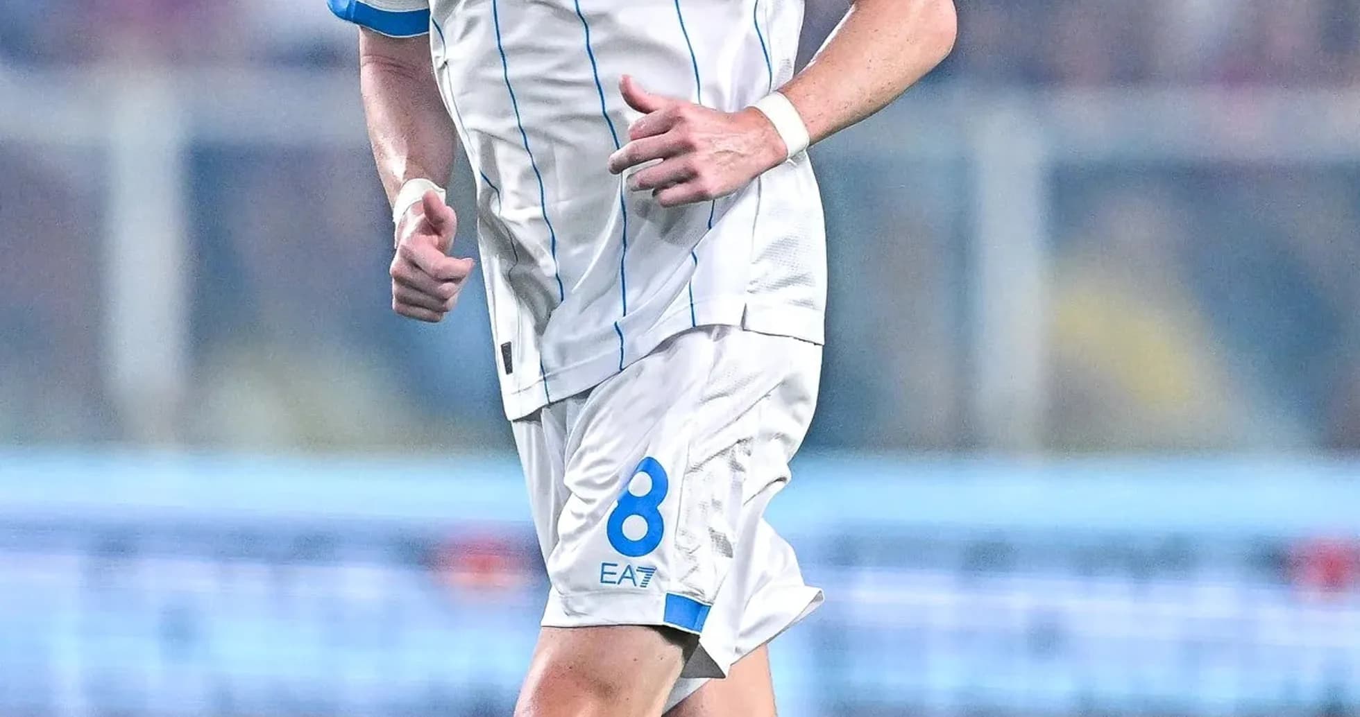 Player in Napoli kit running on the pitch Player in Napoli kit running on the pitch