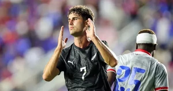 Player gesturing during a soccer match on field Player gesturing during a soccer match on field