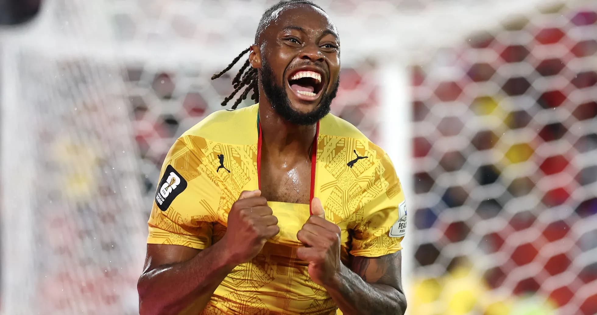 Player celebrating a goal in yellow jersey Player celebrating a goal in yellow jersey