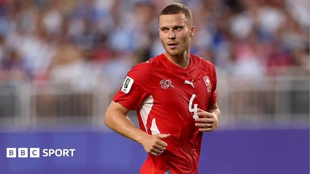 Swiss player running during a football match Swiss player running during a football match