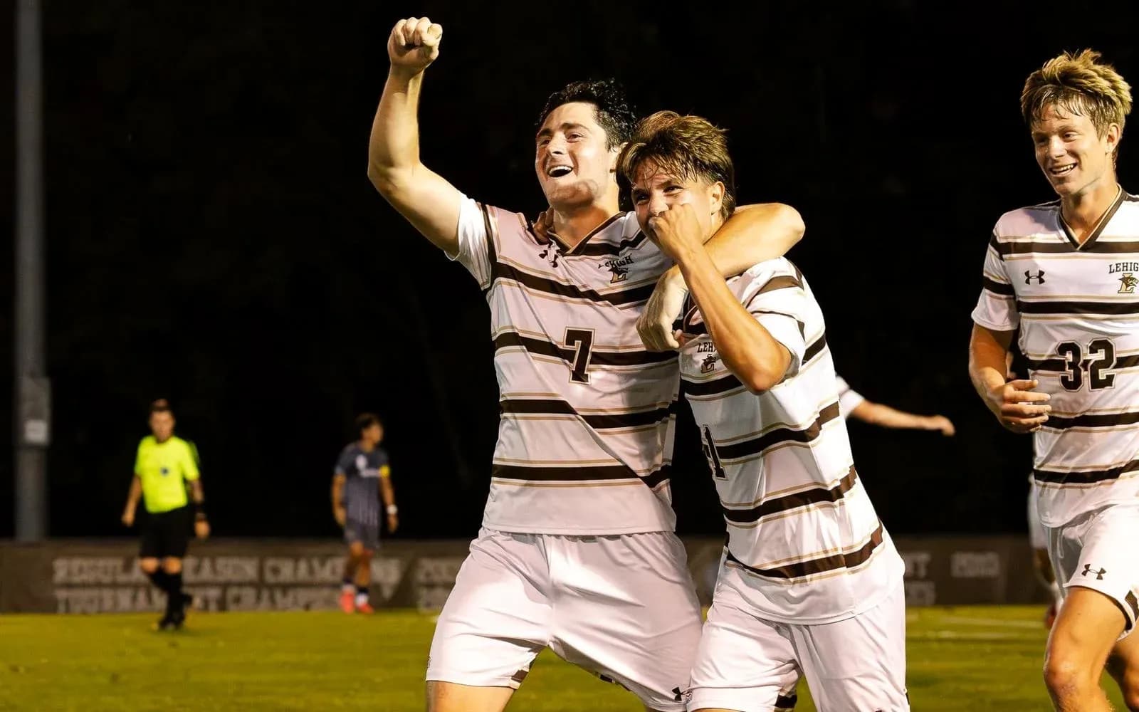 Players celebrating a goal during a soccer match Players celebrating a goal during a soccer match