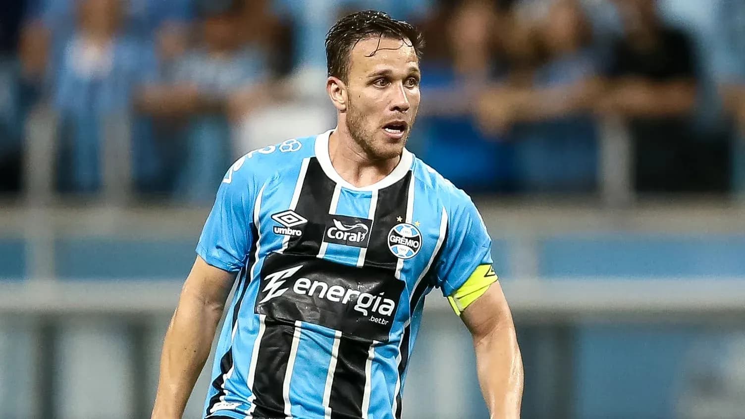 Gremio player in blue and black kit during match Gremio player in blue and black kit during match