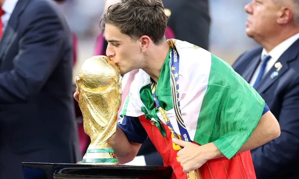 Player kissing the World Cup trophy wearing flag Player kissing the World Cup trophy wearing flag