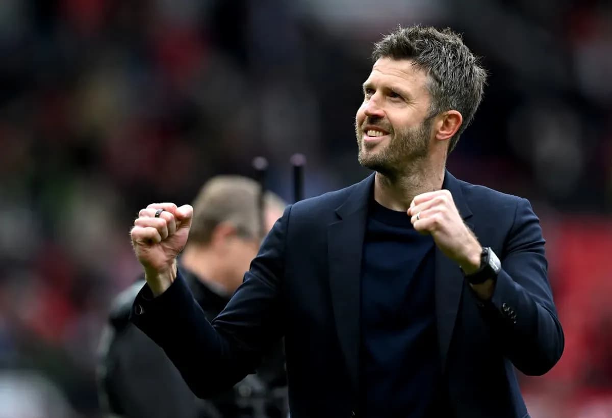 Coach celebrating with clenched fist on pitch Coach celebrating with clenched fist on pitch