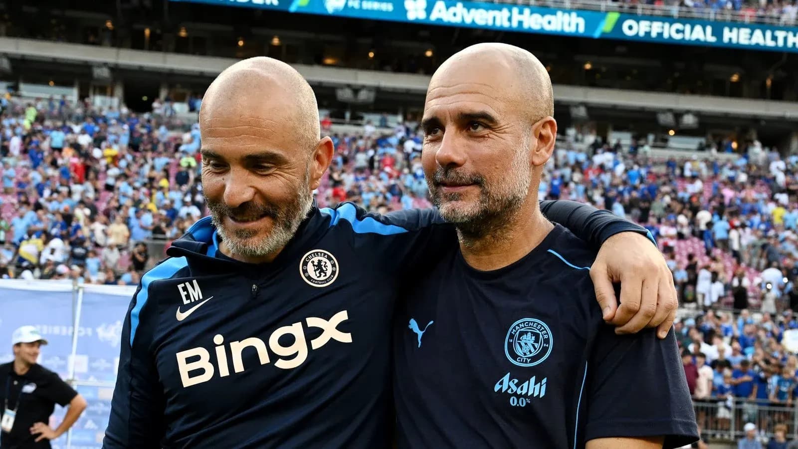 Two coaches smiling together after a match Two coaches smiling together after a match