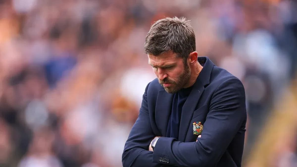 Coach with arms crossed looking down during match Coach with arms crossed looking down during match