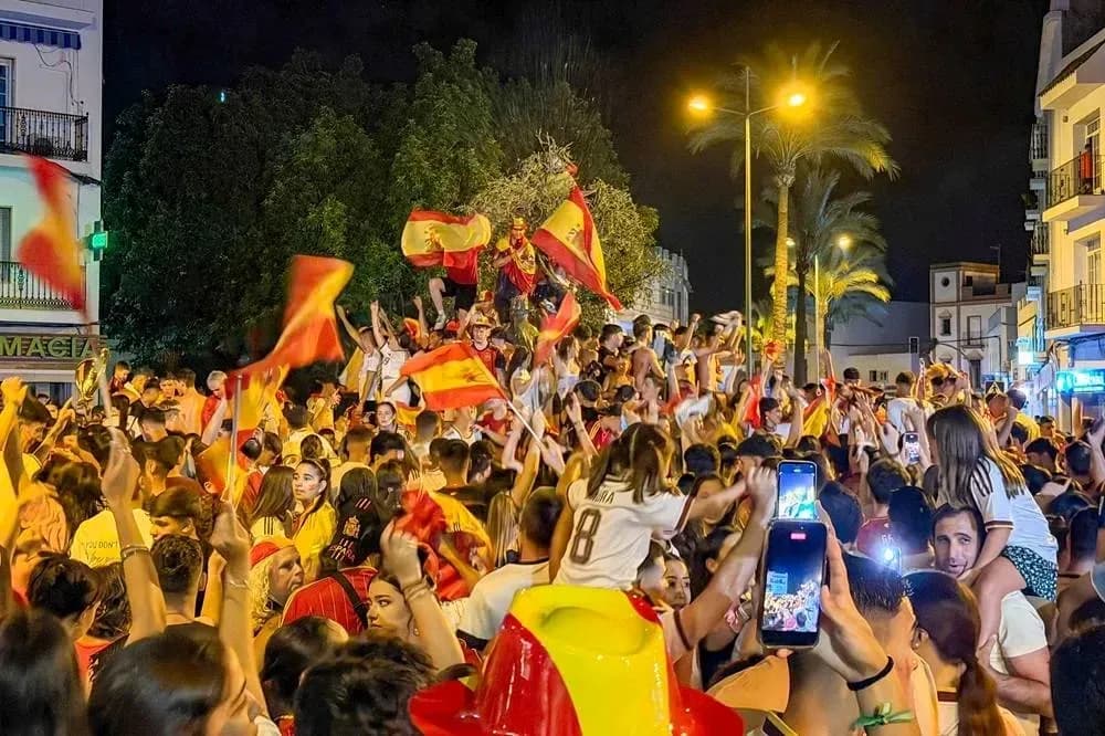 Crowd celebrating with flags in nighttime street Crowd celebrating with flags in nighttime street