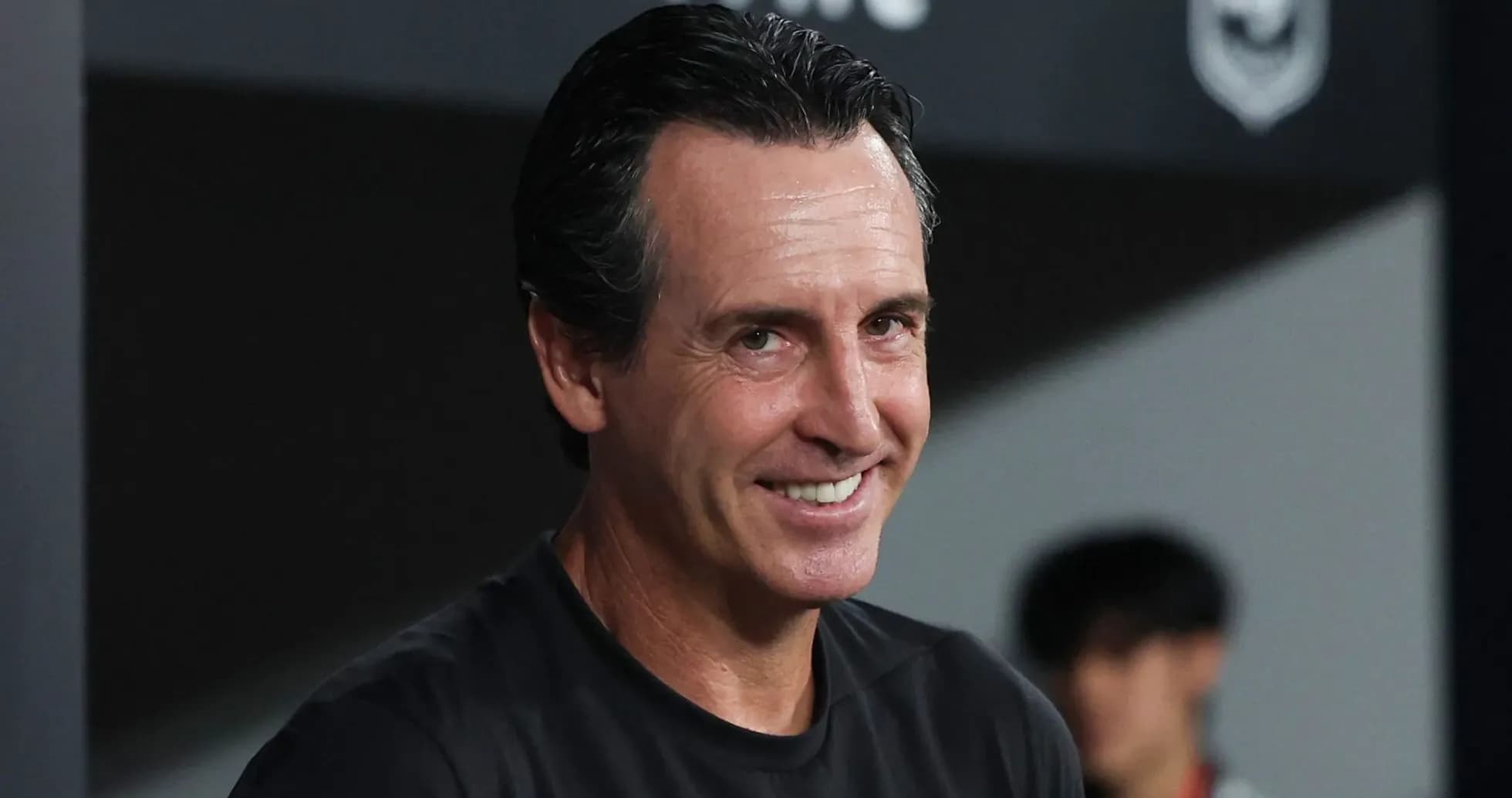 Football manager smiling on the sidelines Football manager smiling on the sidelines