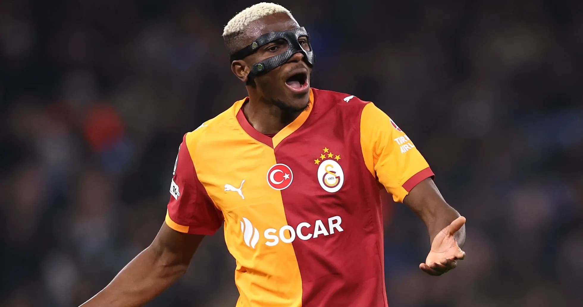 Player celebrating in Galatasaray jersey and mask Player celebrating in Galatasaray jersey and mask
