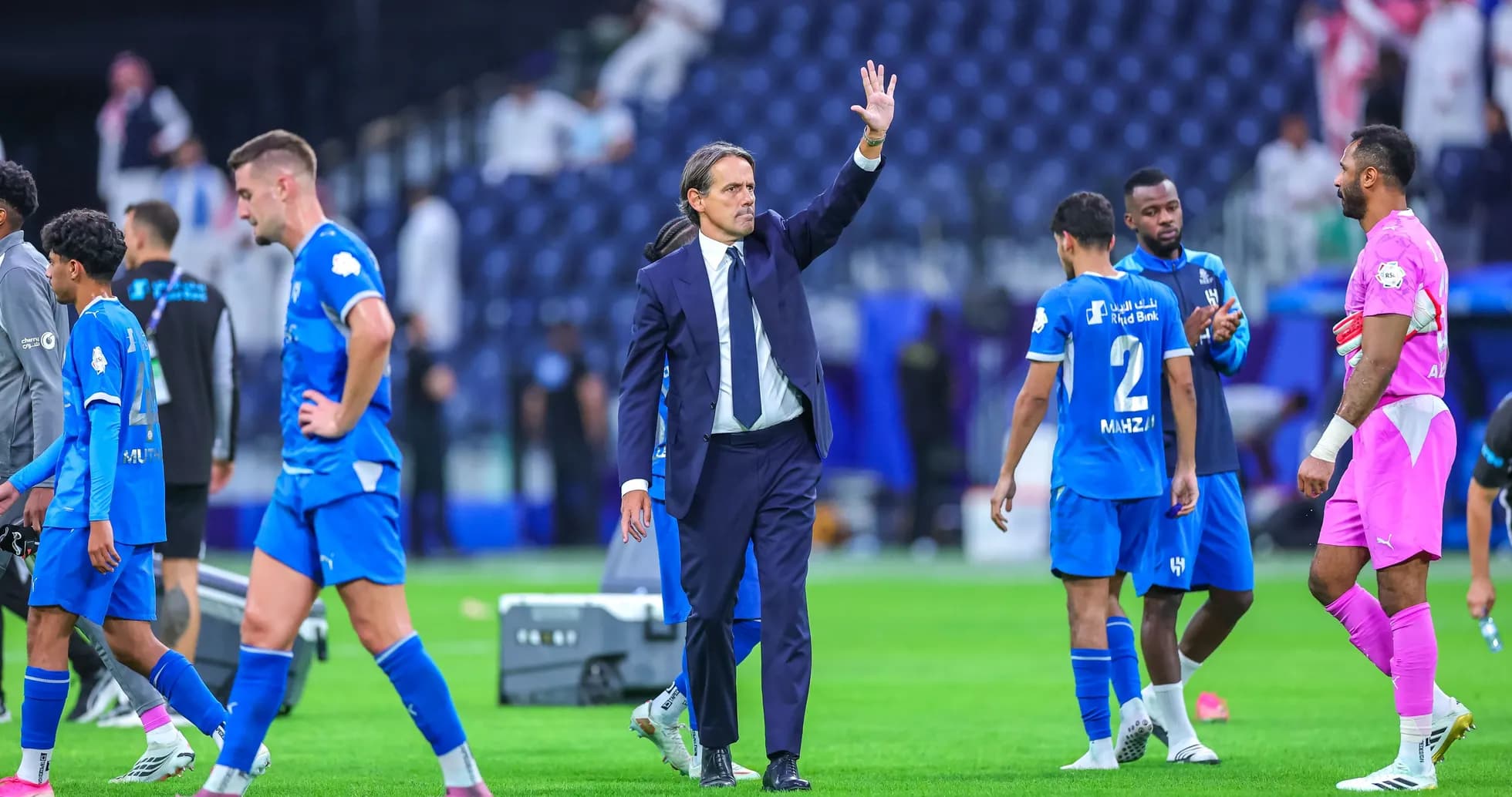 Coach waving to players after match in stadium Coach waving to players after match in stadium