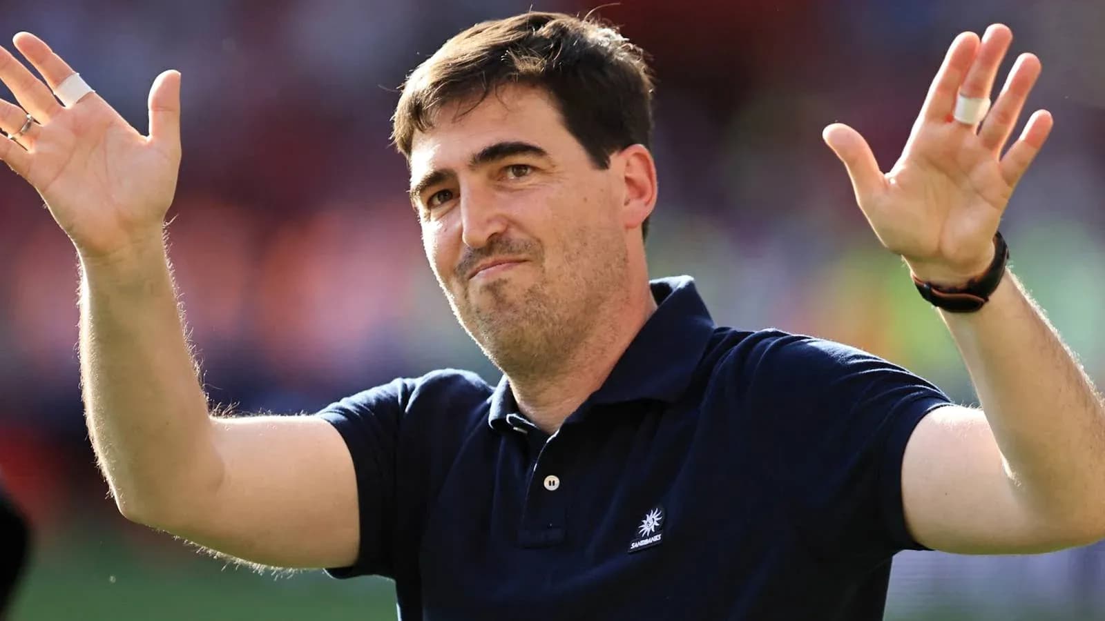 Coach gesturing to fans after match Coach gesturing to fans after match