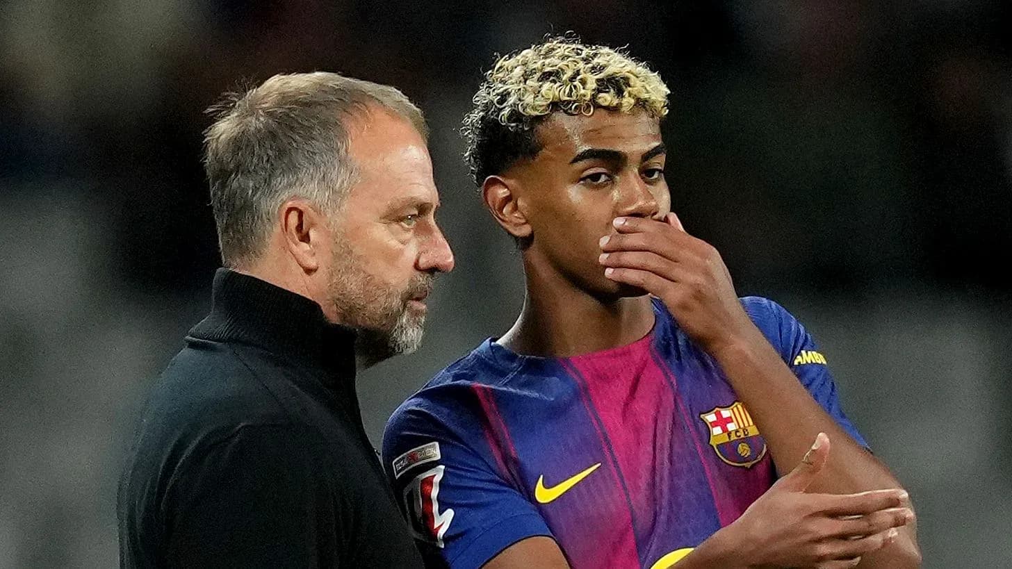 Coach discussing strategy with Barcelona player during match Coach discussing strategy with Barcelona player during match