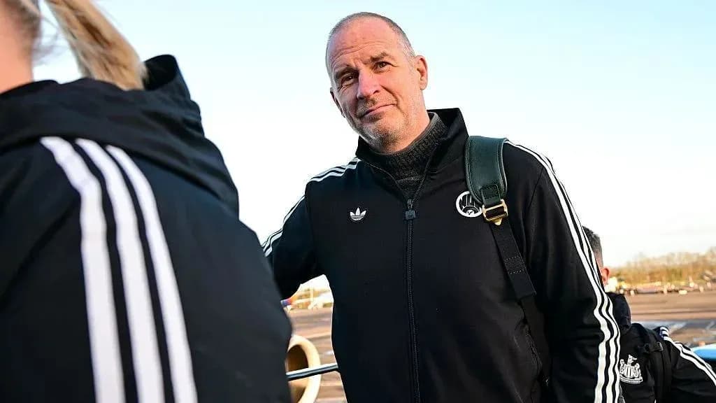 Coach standing near team at the airport Coach standing near team at the airport