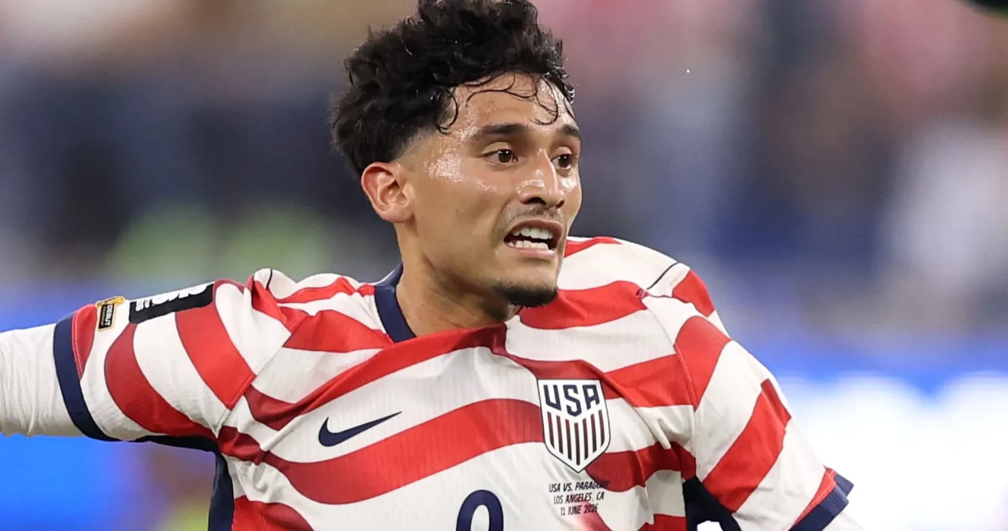 Player in USA jersey during soccer match Player in USA jersey during soccer match