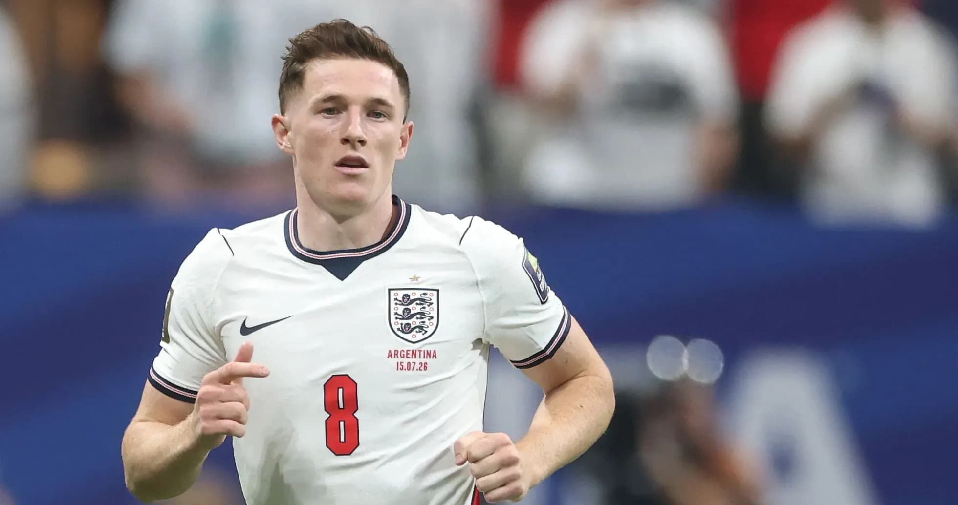 Player wearing England jersey running on field Player wearing England jersey running on field