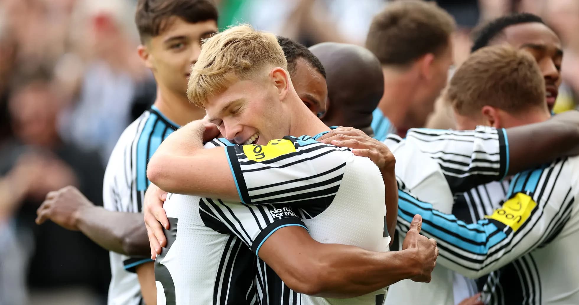 Newcastle players celebrating with hugs after a goal Newcastle players celebrating with hugs after a goal