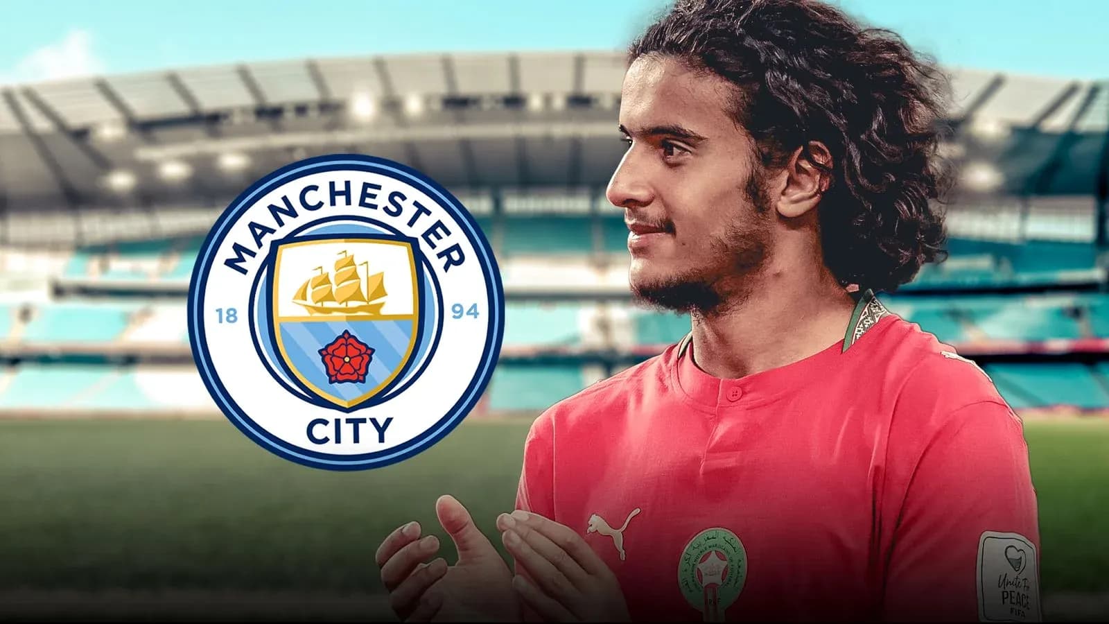 Player in red jersey with Manchester City logo Player in red jersey with Manchester City logo