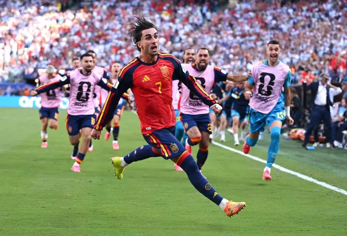 Spanish player celebrating a goal with teammates Spanish player celebrating a goal with teammates