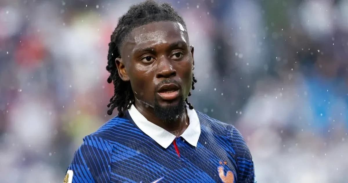 Player in blue jersey during a rainy match Player in blue jersey during a rainy match