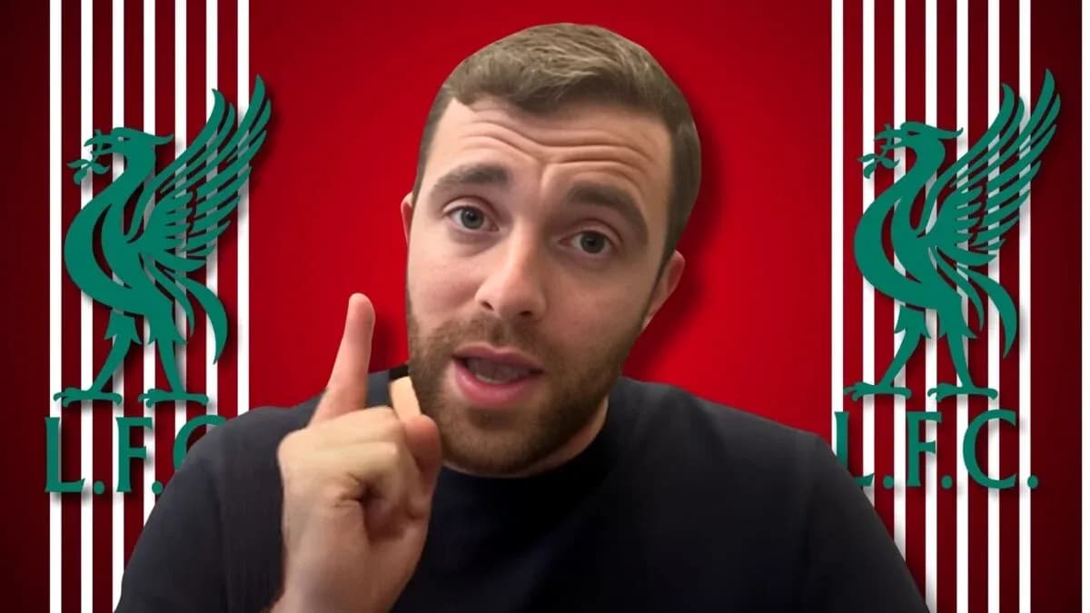 Person speaking with Liverpool FC logos in background Person speaking with Liverpool FC logos in background