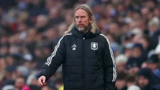 Manager in team jacket on the sidelines Manager in team jacket on the sidelines