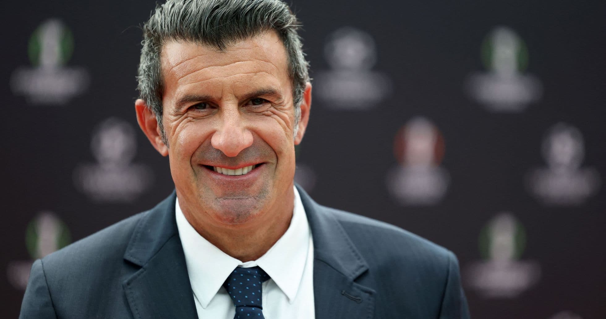 Smiling man in suit at press event Smiling man in suit at press event