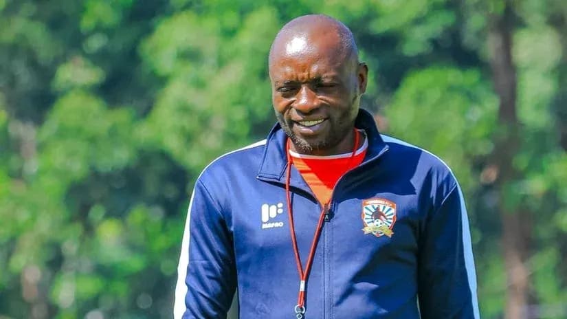 Coach walking on training ground in team tracksuit Coach walking on training ground in team tracksuit