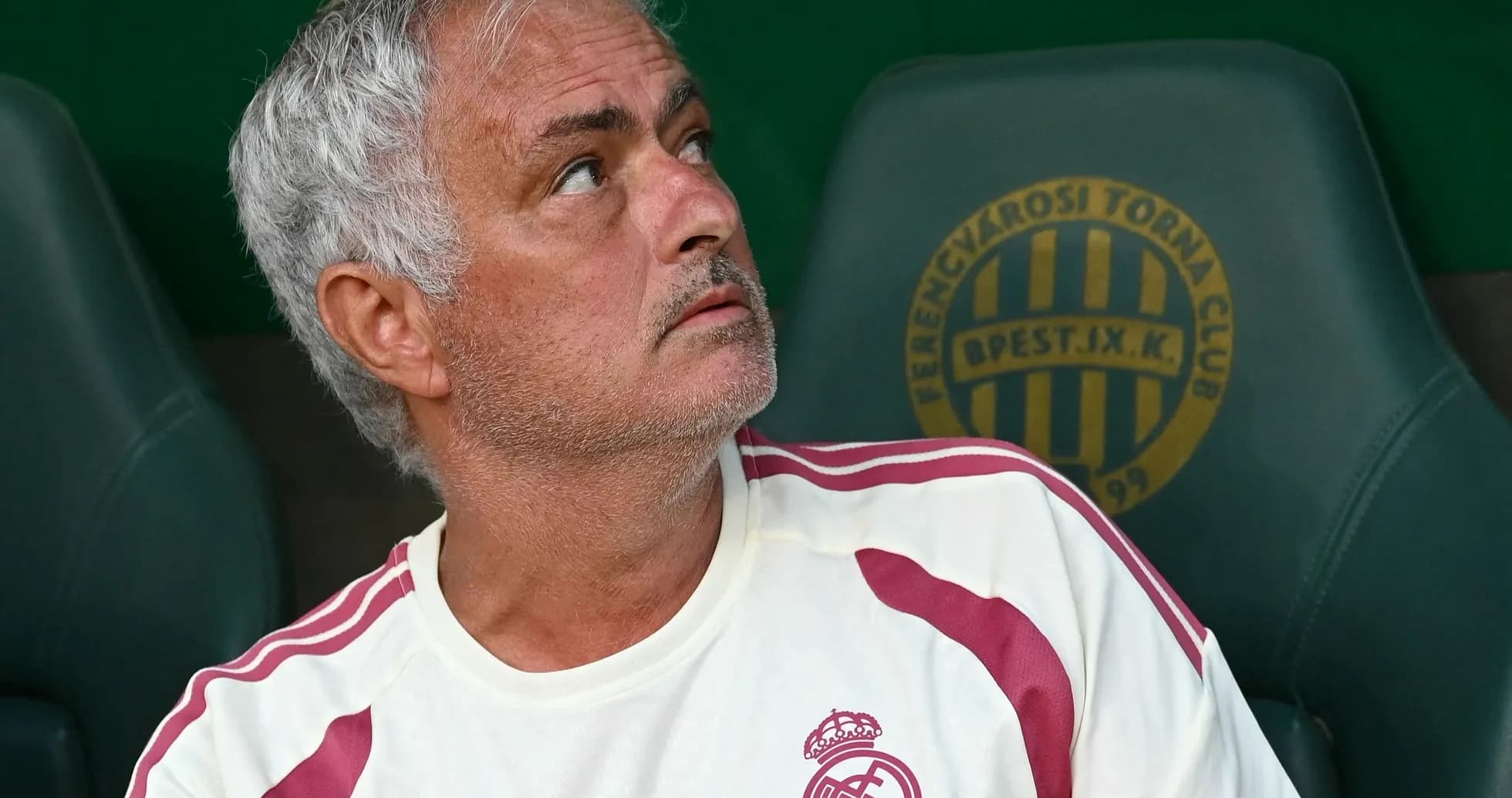 Coach sitting on bench during match, looking up Coach sitting on bench during match, looking up