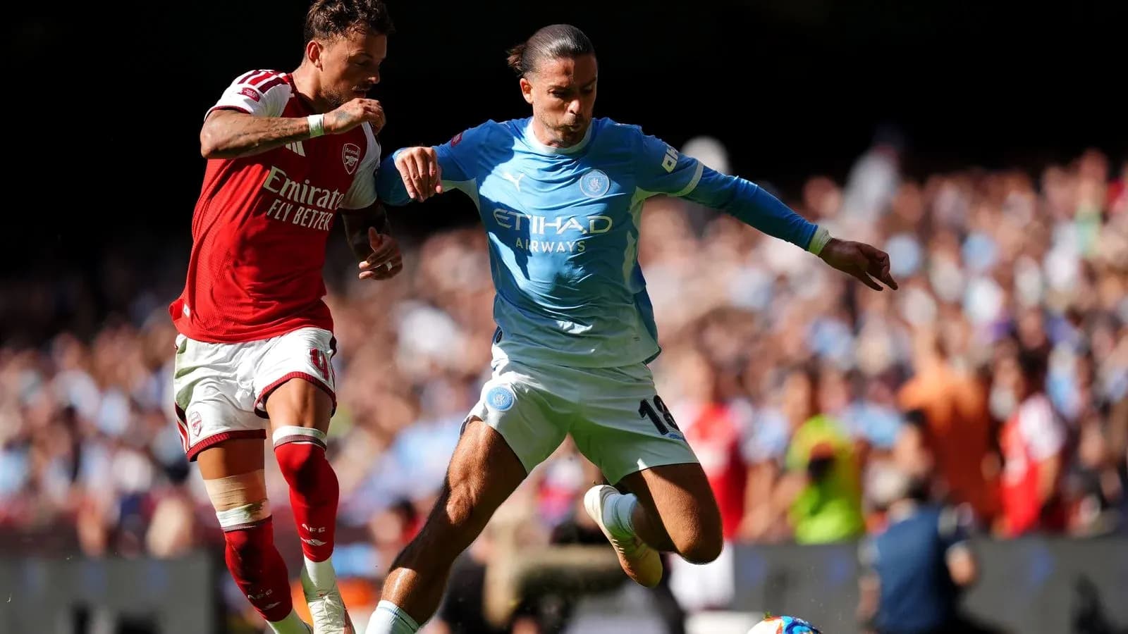 Players from Arsenal and Manchester City battling for the ball Players from Arsenal and Manchester City battling for the ball